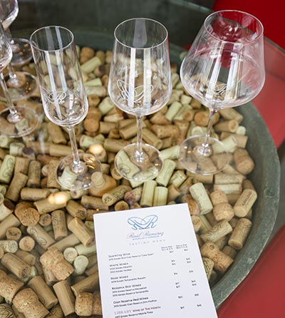 Photo of three wine glasses on a table top.